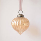 2 inch champagne gold ribbed glass lantern ornament with a bronze cap and ribbon hanger, made in India