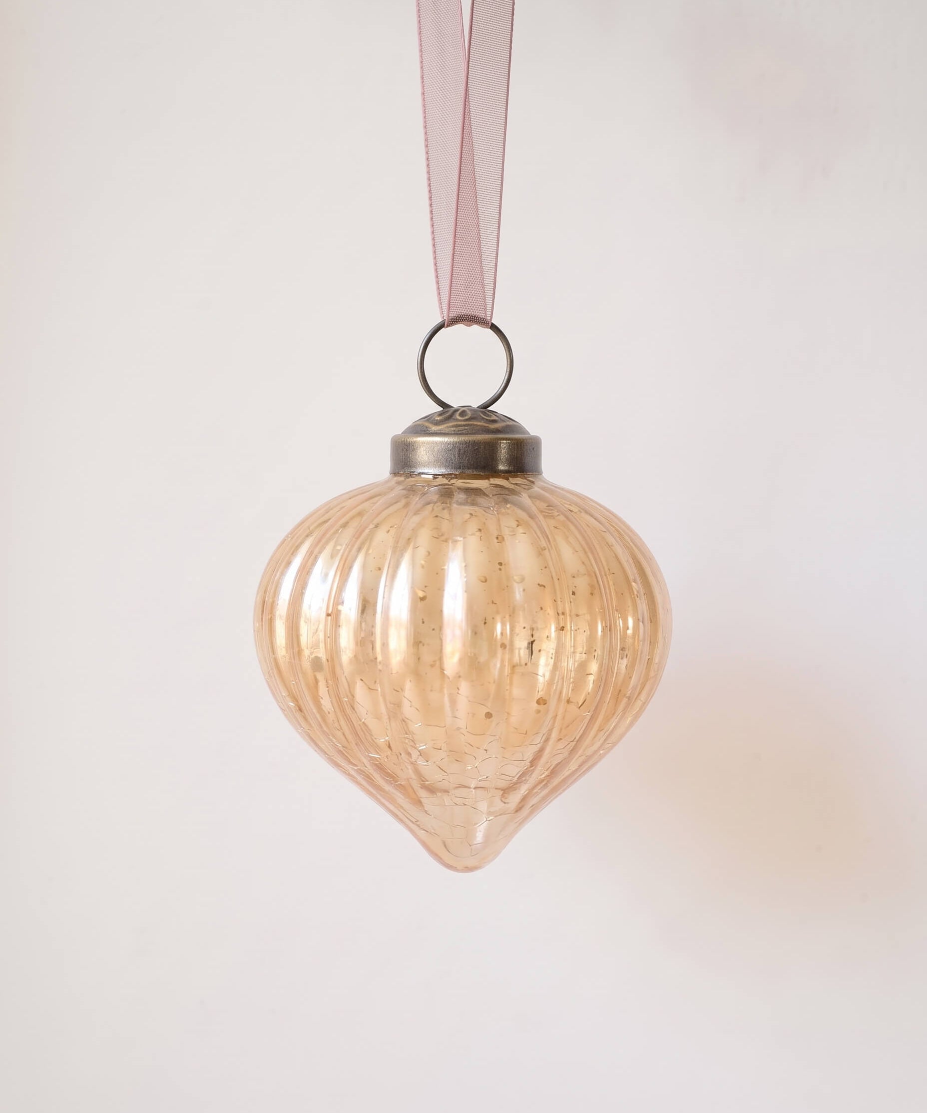 2 inch champagne gold ribbed glass lantern ornament with a bronze cap and ribbon hanger, made in India