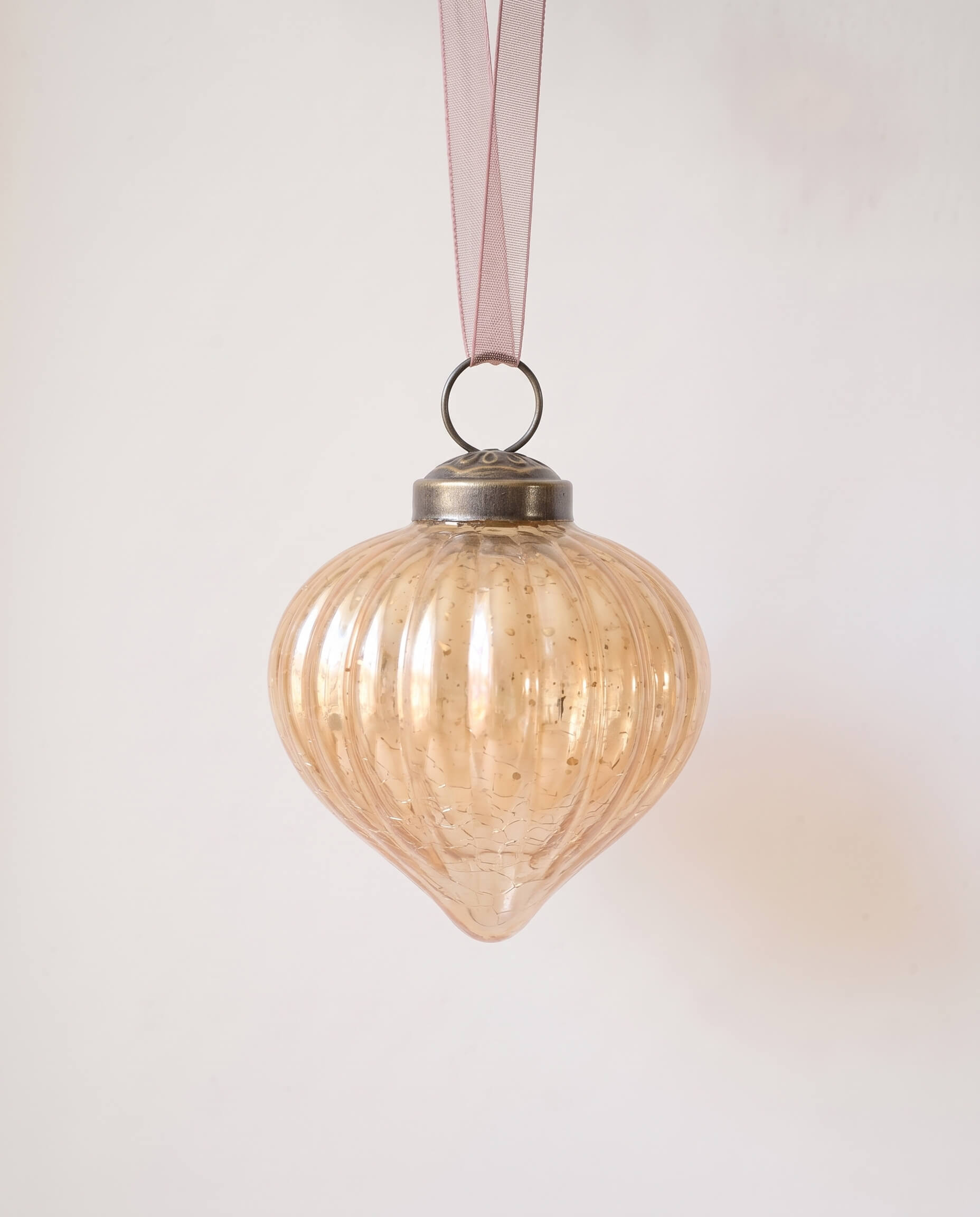 2 inch champagne gold ribbed glass lantern ornament with a bronze cap and ribbon hanger, made in India