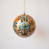 2 inch gold papier-mache Christmas ornament hand-painted with a Kashmiri floral motif