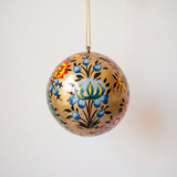 2 inch gold papier-mache Christmas ornament hand-painted with a Kashmiri floral motif