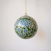 2 inch turquoise-green papier-mache ornament hand-painted with a Kashmiri floral motif