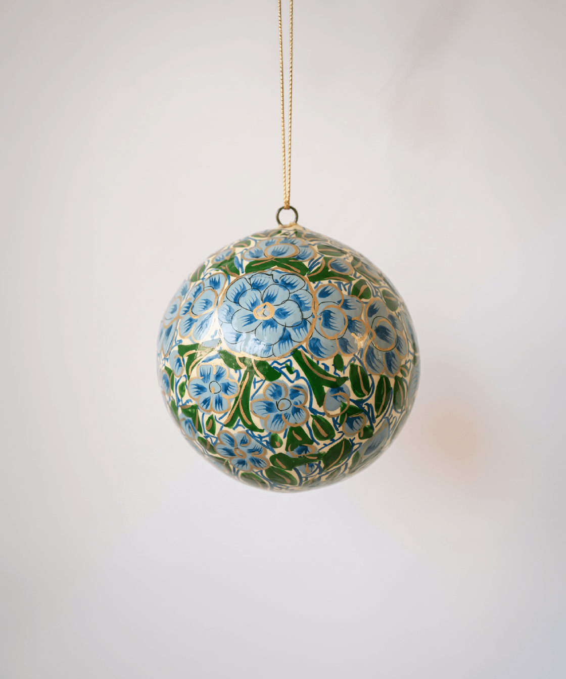2 inch turquoise-green papier-mache ornament hand-painted with a Kashmiri floral motif