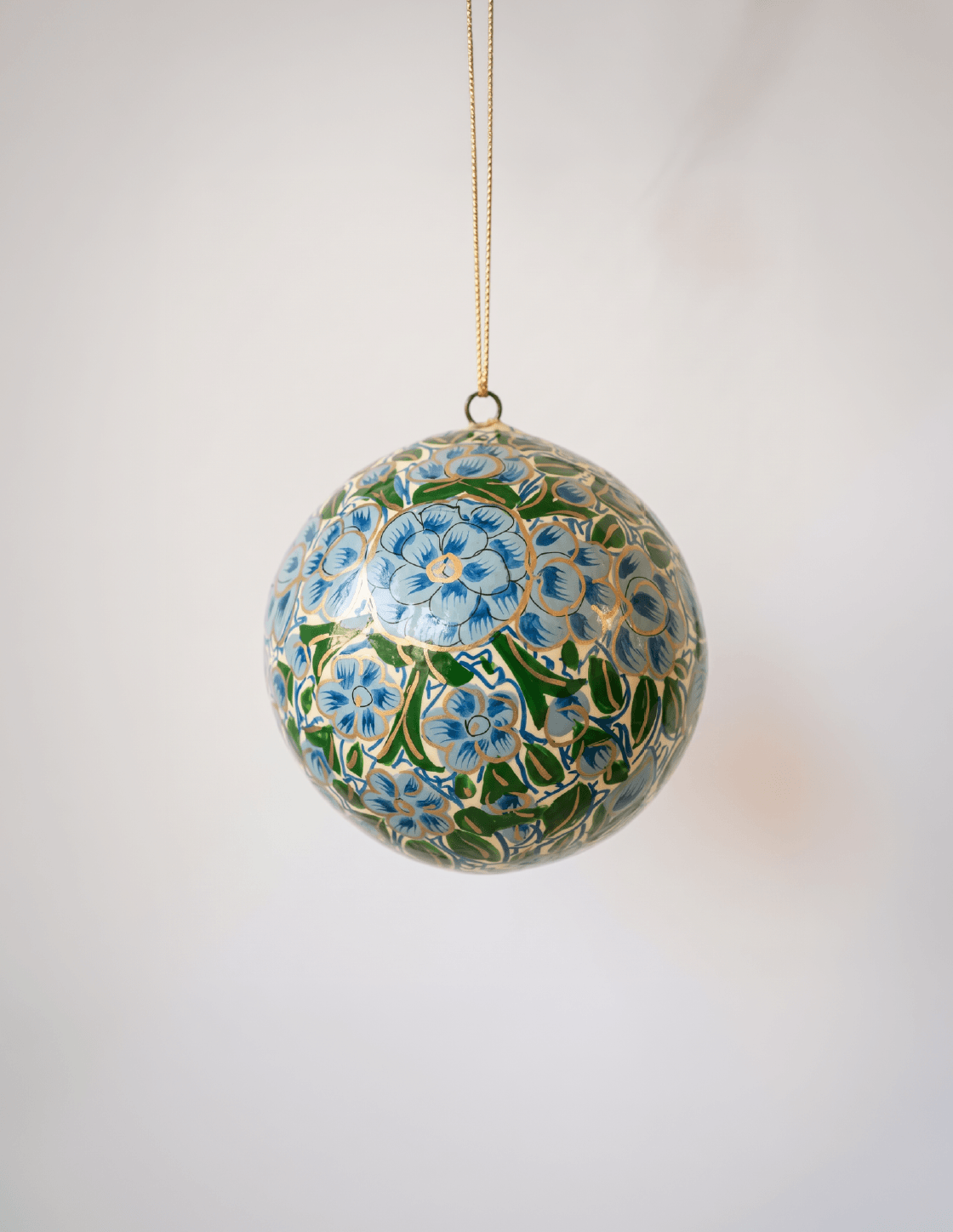 2 inch turquoise-green papier-mache ornament hand-painted with a Kashmiri floral motif