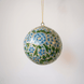 2 inch turquoise-green papier-mache ornament hand-painted with a Kashmiri floral motif