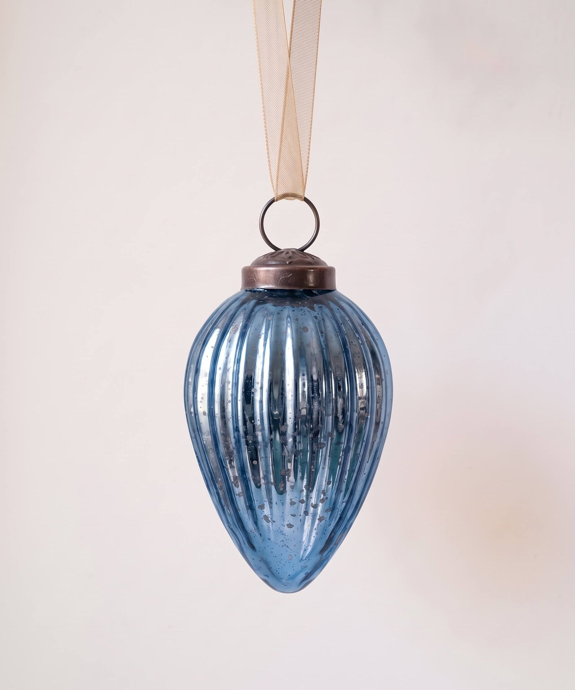 2 inch deep navy pressed glass pinecone ornament with a bronze cap and ribbon hanger, made in India
