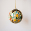 3 inch papier-mache Christmas ornament hand-painted with a multicoloured Kashmiri floral motif