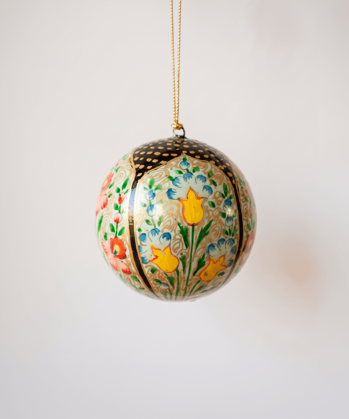 3 inch papier-mache Christmas ornament hand-painted with a multicoloured Kashmiri floral motif