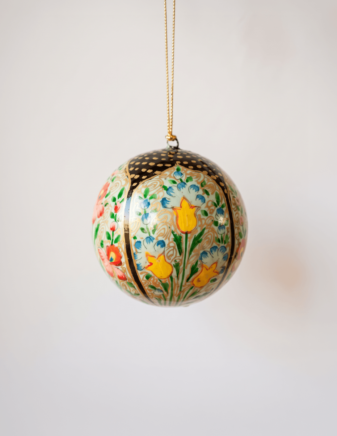 3 inch papier-mache Christmas ornament hand-painted with a multicoloured Kashmiri floral motif