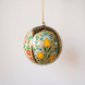 3 inch papier-mache Christmas ornament hand-painted with a multicoloured Kashmiri floral motif