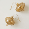 Hand-blown amber glass saucer ornament painted with a gold diamond harlequin pattern, made in Old Cairo, Egypt