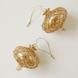 Hand-blown amber glass saucer ornament painted with a gold diamond harlequin pattern, made in Old Cairo, Egypt