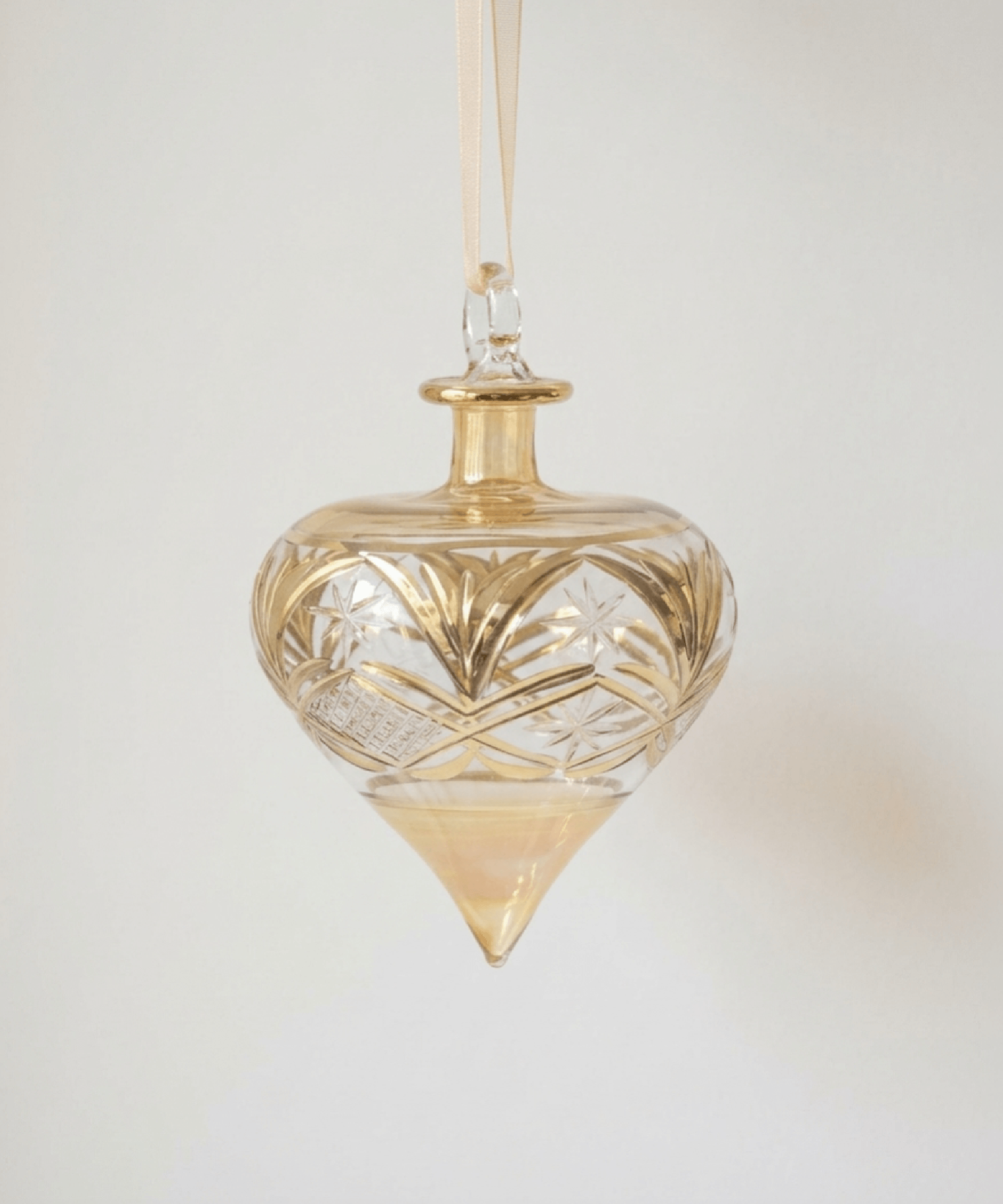 Hand-blown amber glass droplet ornament brushed with gold accents, made in Old Cairo, Egypt