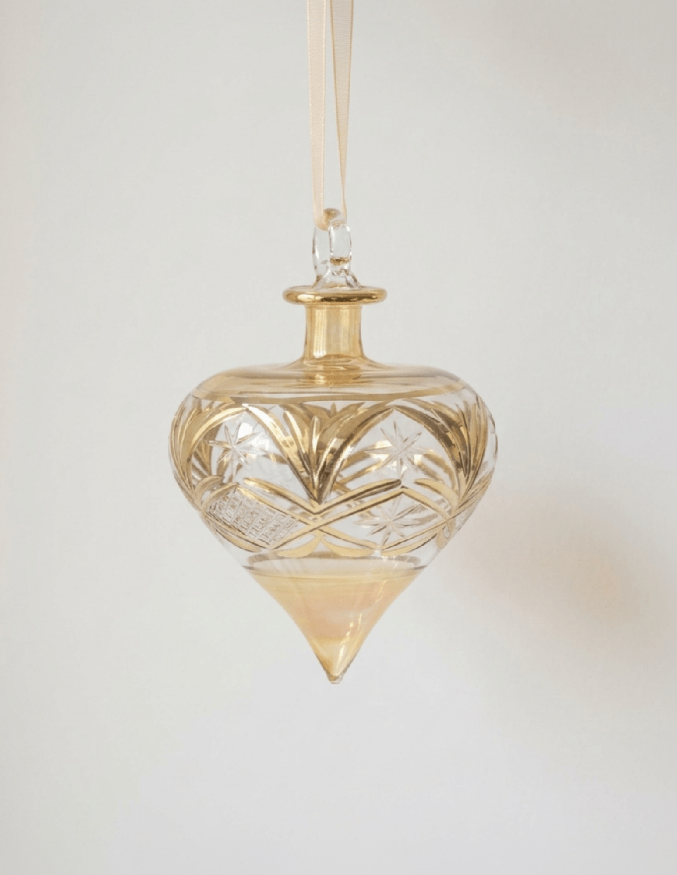 Hand-blown amber glass droplet ornament brushed with gold accents, made in Old Cairo, Egypt