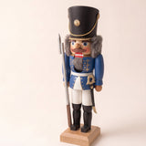 Blue hand-painted wooden nutcracker soldier in a traditional uniform, made in Seiffen, Germany