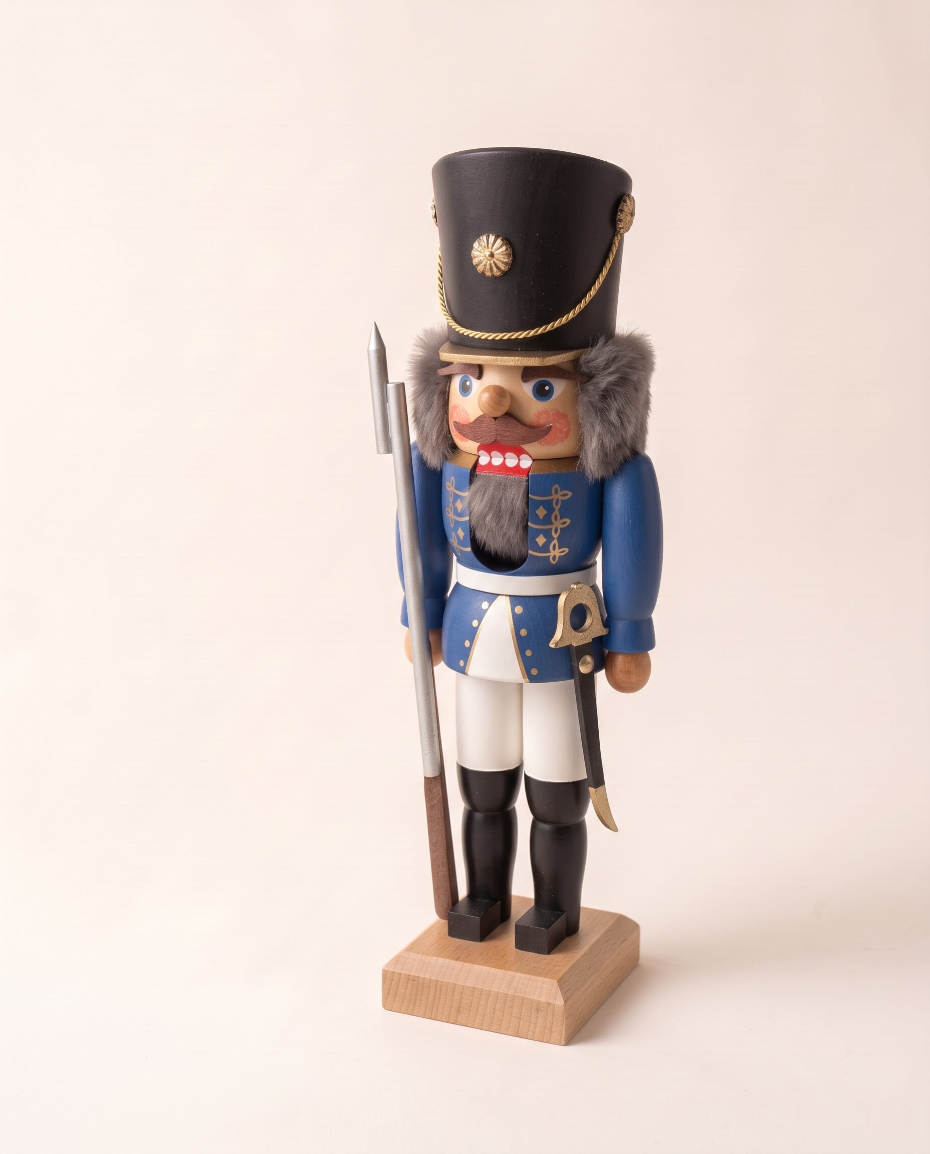 Blue hand-painted wooden nutcracker soldier in a traditional uniform, made in Seiffen, Germany