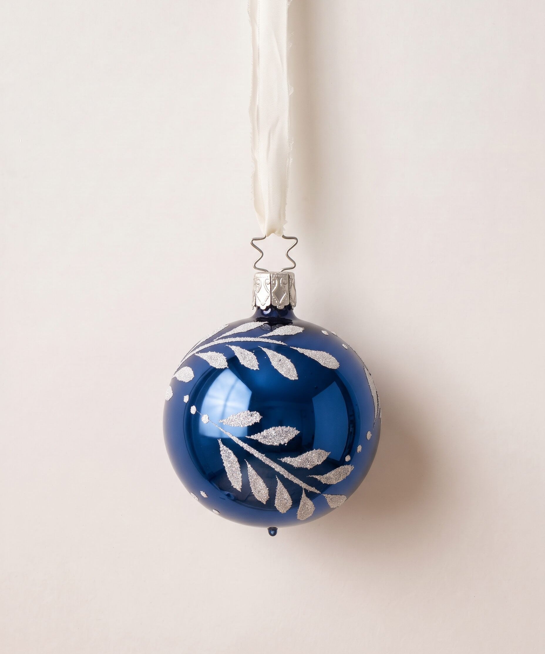 Midnight blue mouth-blown glass ornament with hand-painted gold and silver leaves, by Inge-Glas of Germany
