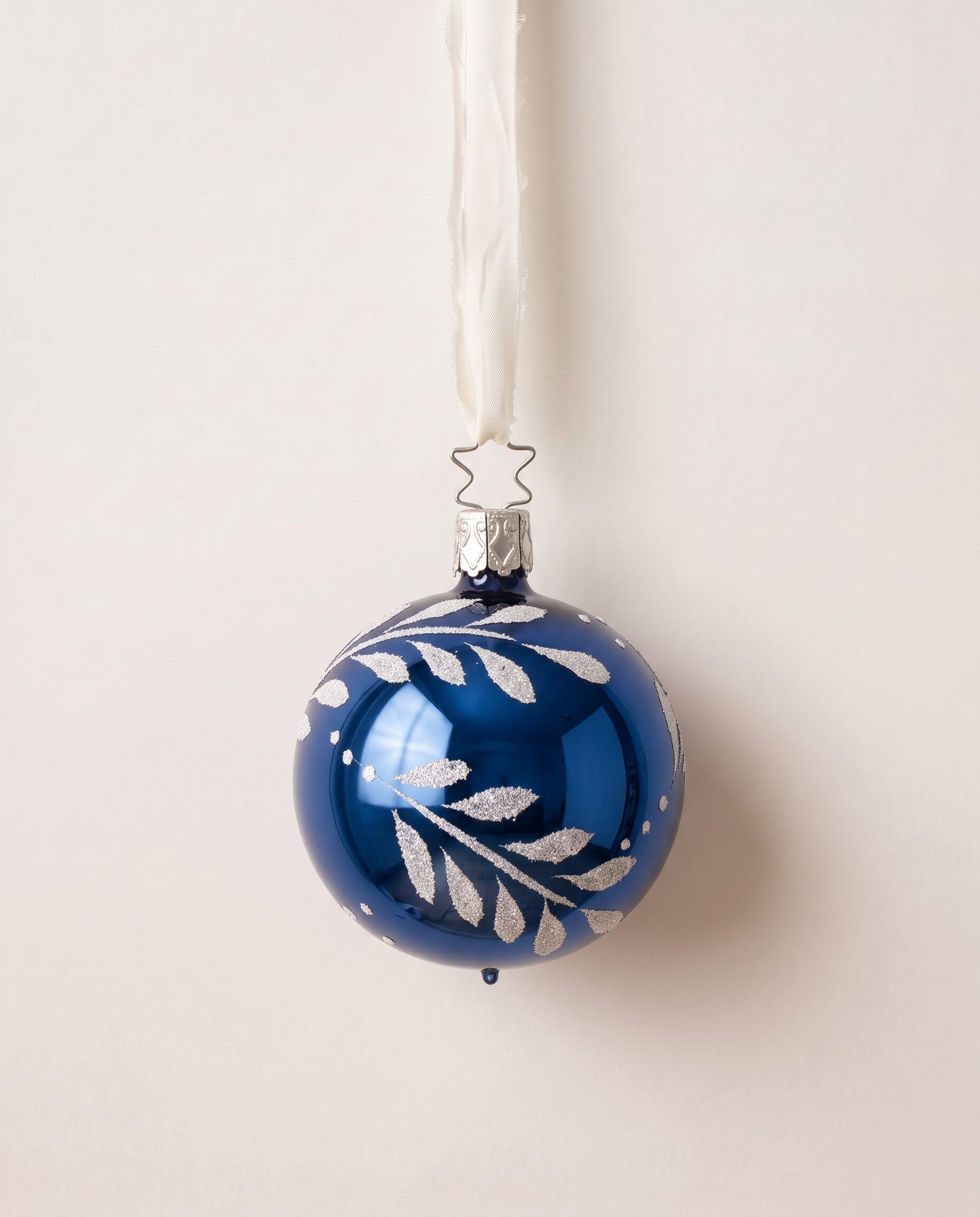 Midnight blue mouth-blown glass ornament with hand-painted gold and silver leaves, by Inge-Glas of Germany