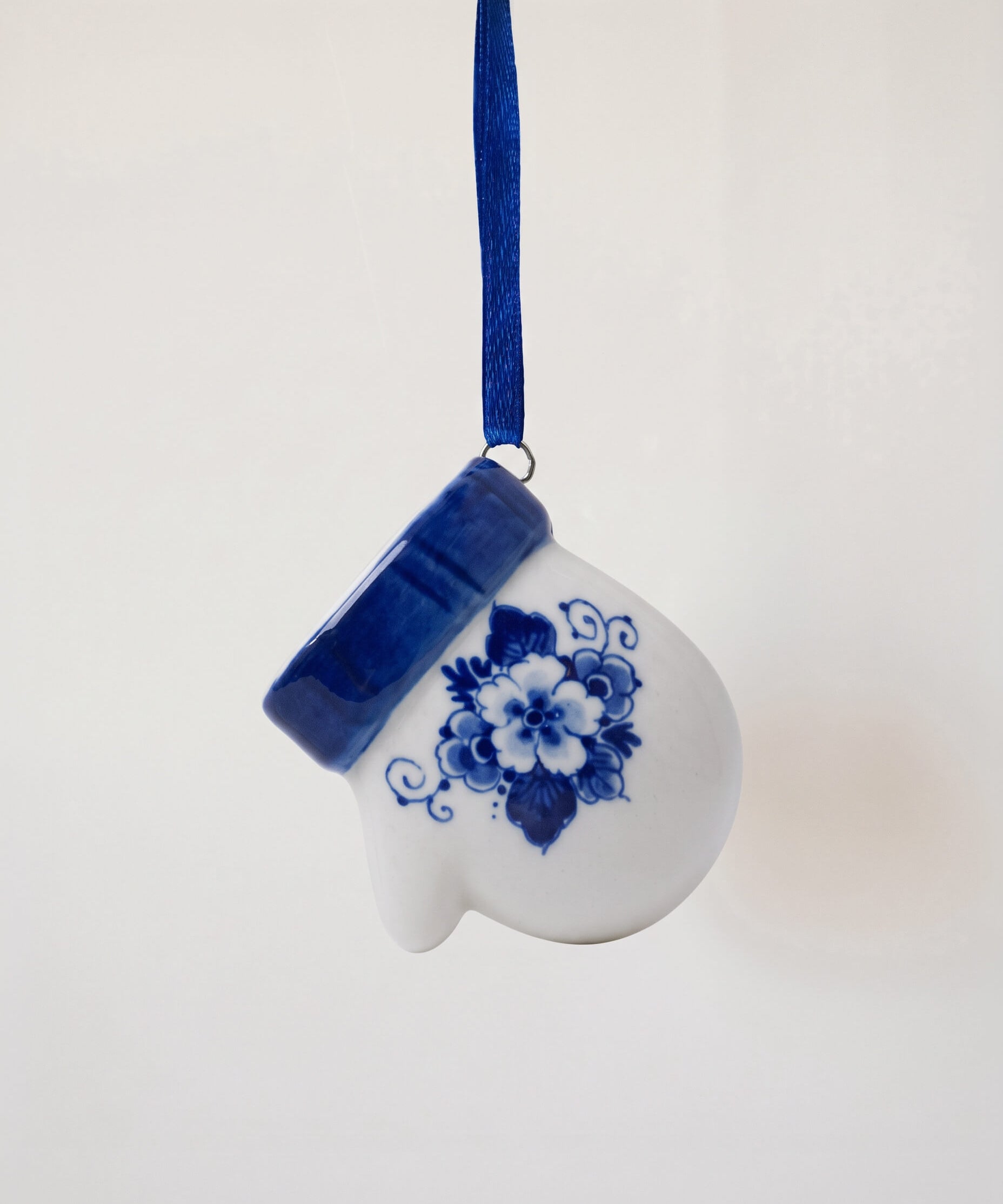 Delft blue hand-painted porcelain mitten ornament on a blue satin ribbon, made in Delft, Netherlands