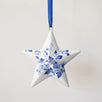 Porcelain star ornament hand-painted with a Delft blue floral motif, made in Delft, Netherlands