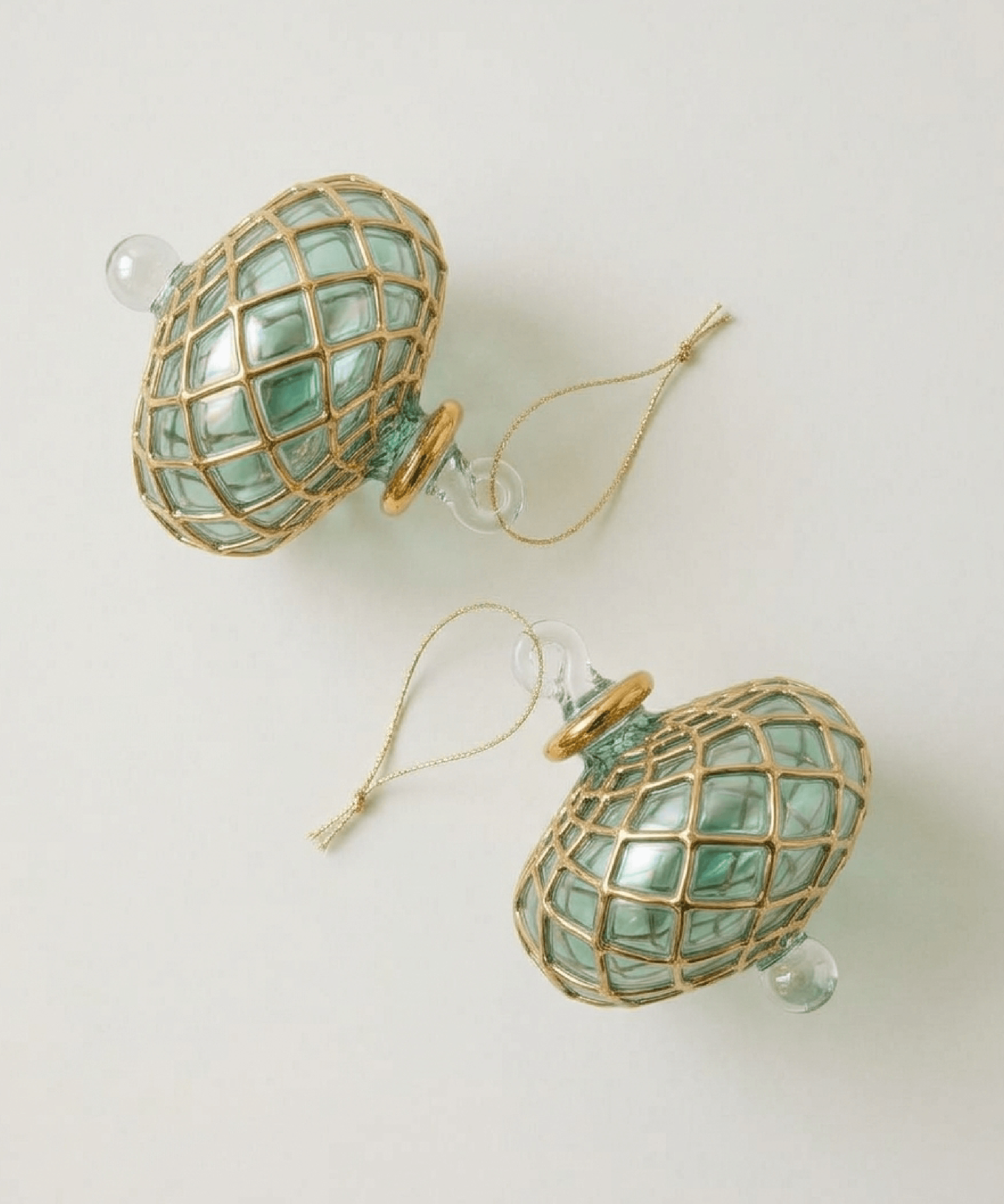 Hand-blown emerald green glass saucer ornament with a gold diamond harlequin pattern, made in Old Cairo, Egypt