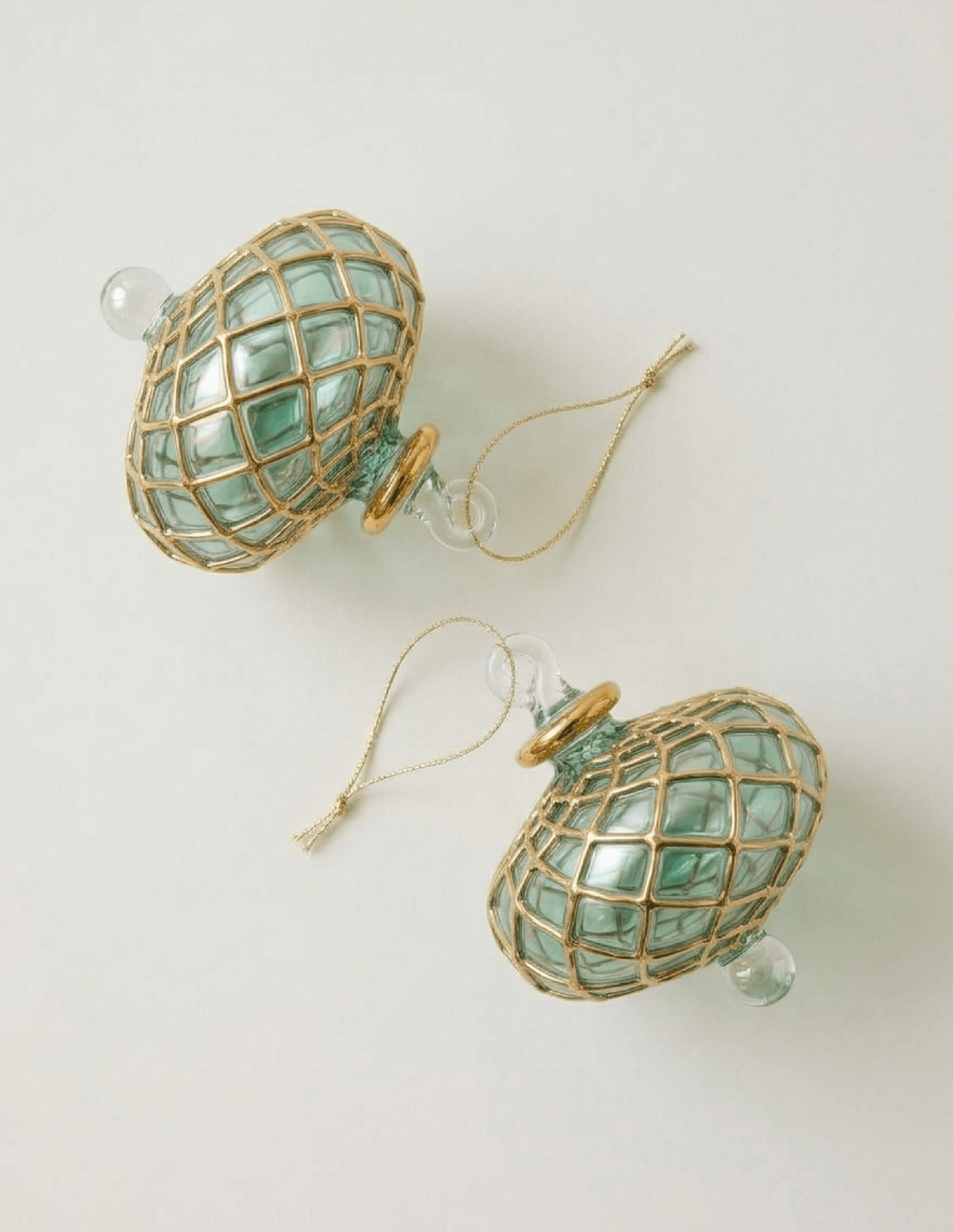 Hand-blown emerald green glass saucer ornament with a gold diamond harlequin pattern, made in Old Cairo, Egypt