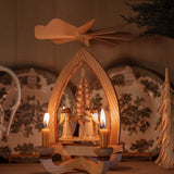 Hand-carved lime wood candle pyramid with trumpeting angels and gold detail, made in Seiffen, Germany