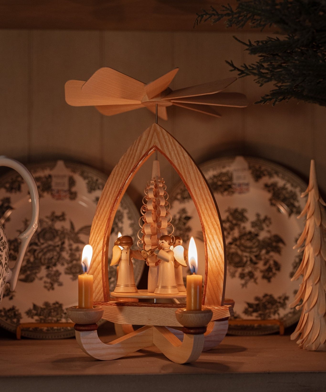 Hand-carved lime wood candle pyramid with trumpeting angels and gold detail, made in Seiffen, Germany