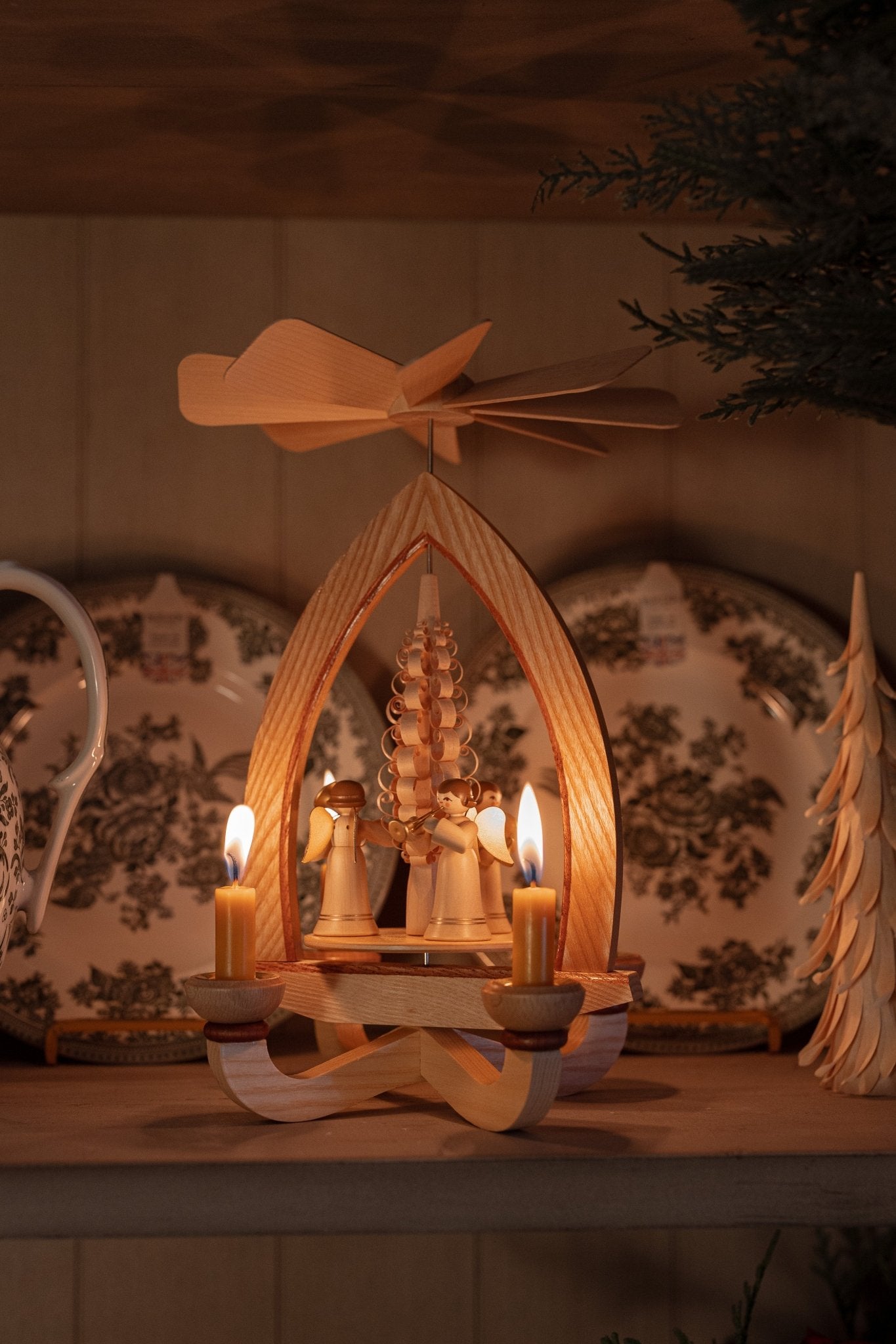 Hand-carved lime wood candle pyramid with trumpeting angels and gold detail, made in Seiffen, Germany