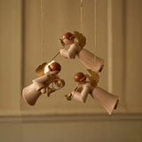 Hand-carved lime wood angel ornament holding a brass instrument, made by woodcarvers in Seiffen, Germany