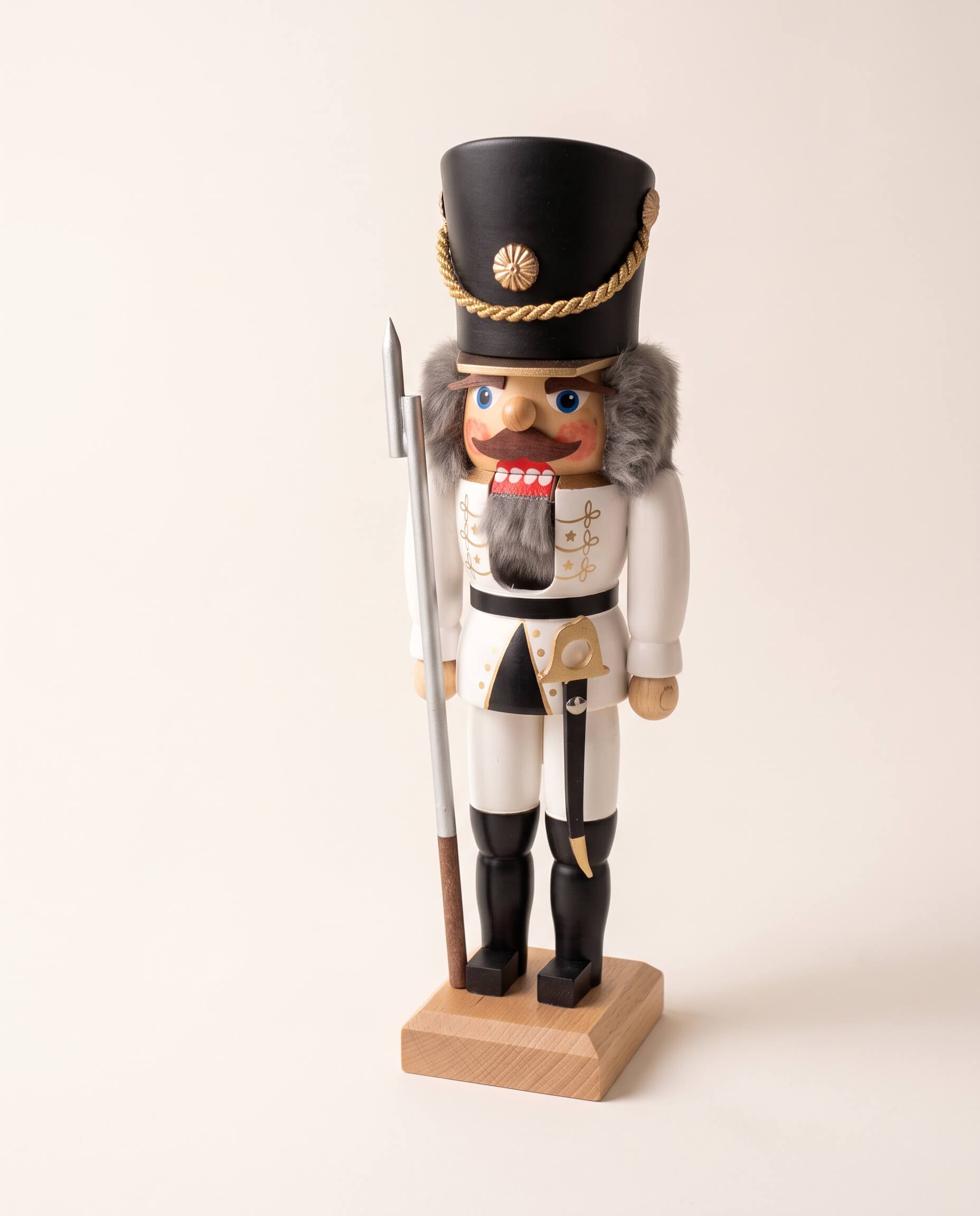 White and gold hand-painted wooden nutcracker soldier, made in Seiffen, Germany