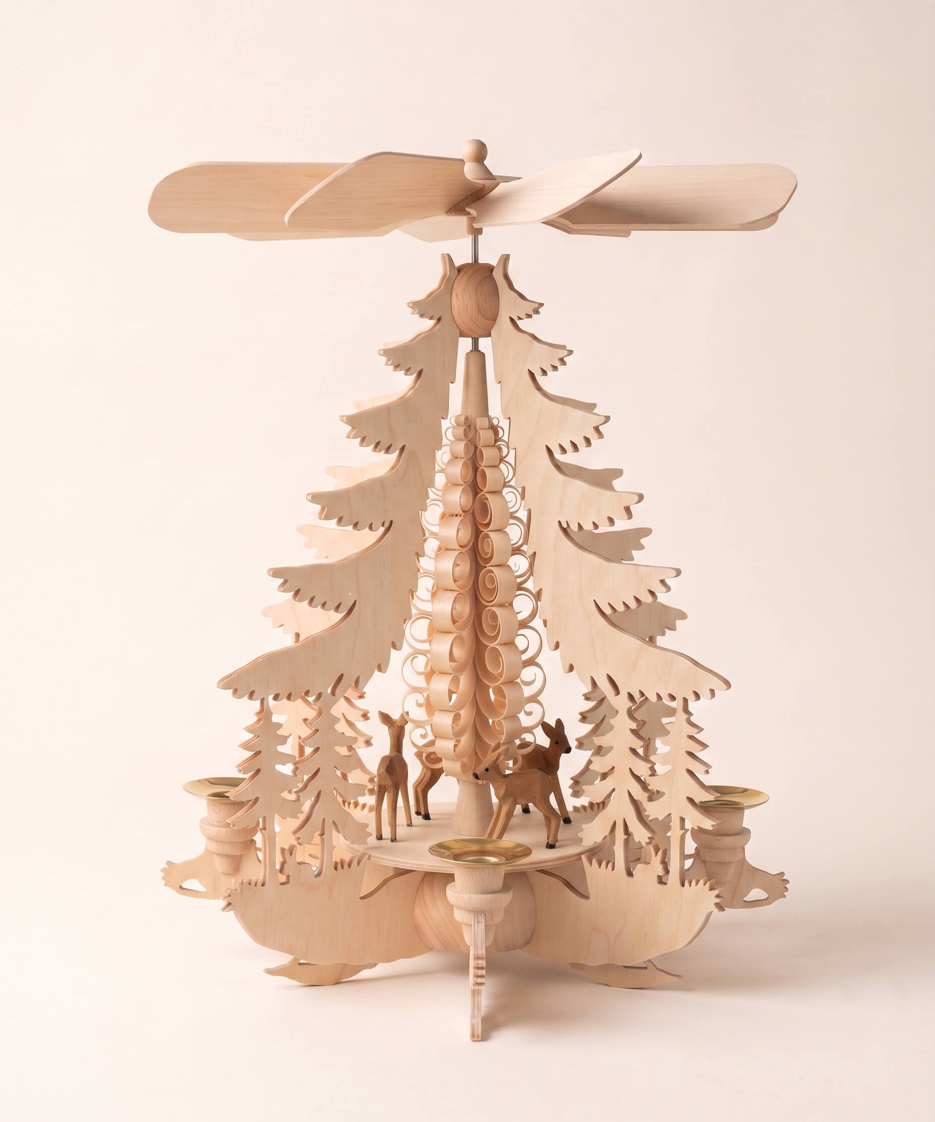 Hand-carved lime wood candle pyramid with deer and evergreens in a forest scene, another view