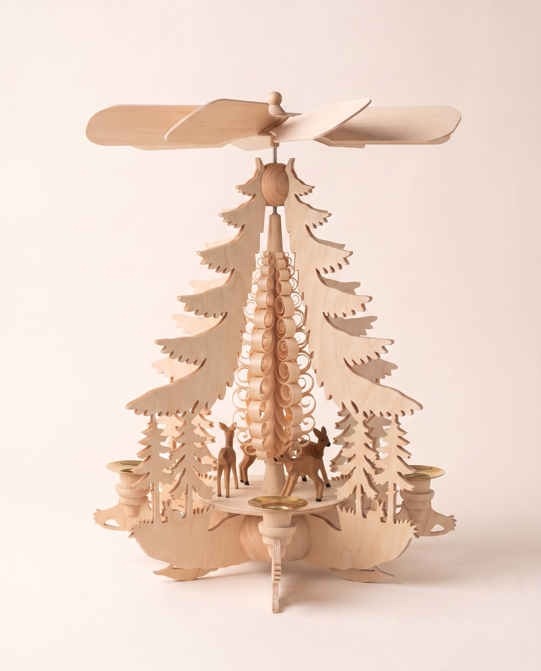 Hand-carved lime wood candle pyramid with deer and evergreens in a forest scene, another view