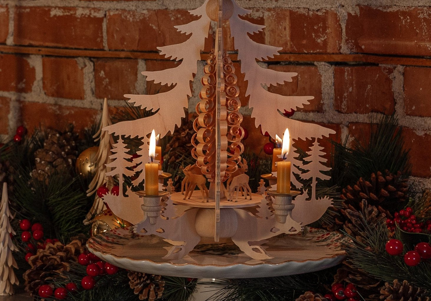 Hand-carved lime wood candle pyramid with deer and evergreens in a forest scene, made in Seiffen, Germany