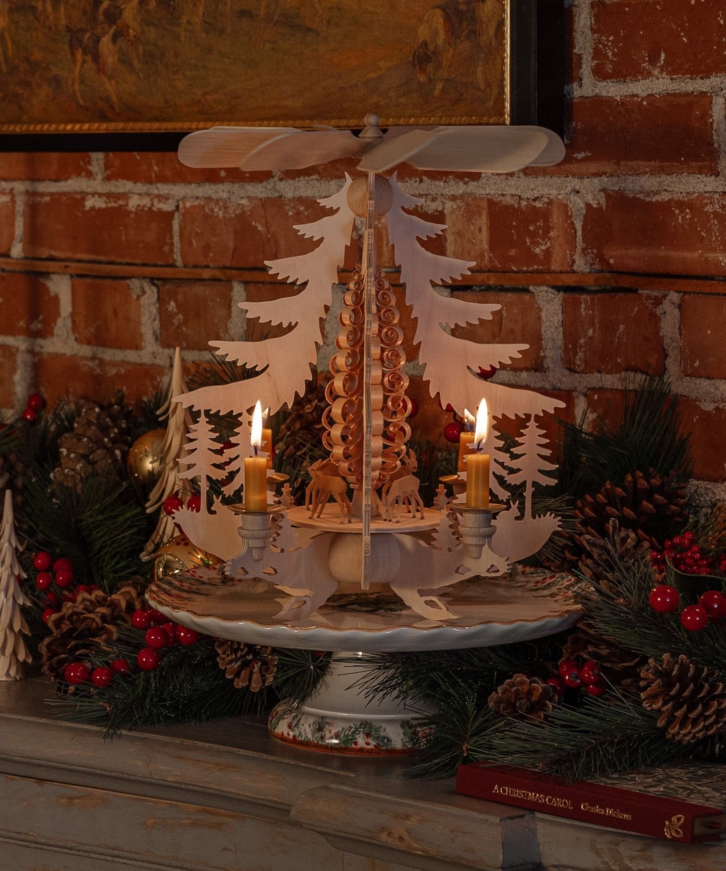 Hand-carved lime wood candle pyramid with deer and evergreens in a forest scene, made in Seiffen, Germany