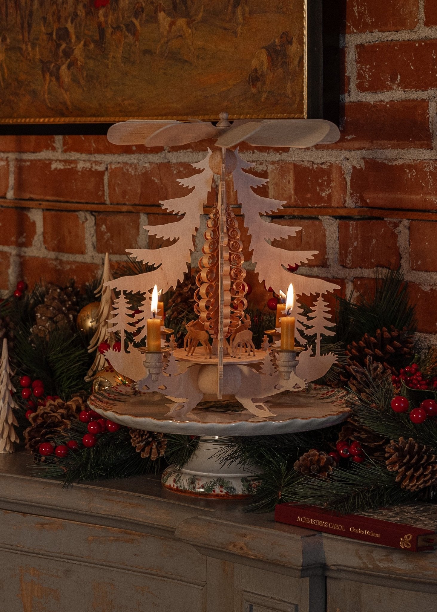 Hand-carved lime wood candle pyramid with deer and evergreens in a forest scene, made in Seiffen, Germany