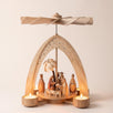Hand-painted wooden nativity tealight pyramid with the Holy Family and wise men under a star-cut arch, made in Seiffen