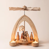 Hand-painted wooden nativity tealight pyramid with the Holy Family and wise men under a star-cut arch, made in Seiffen