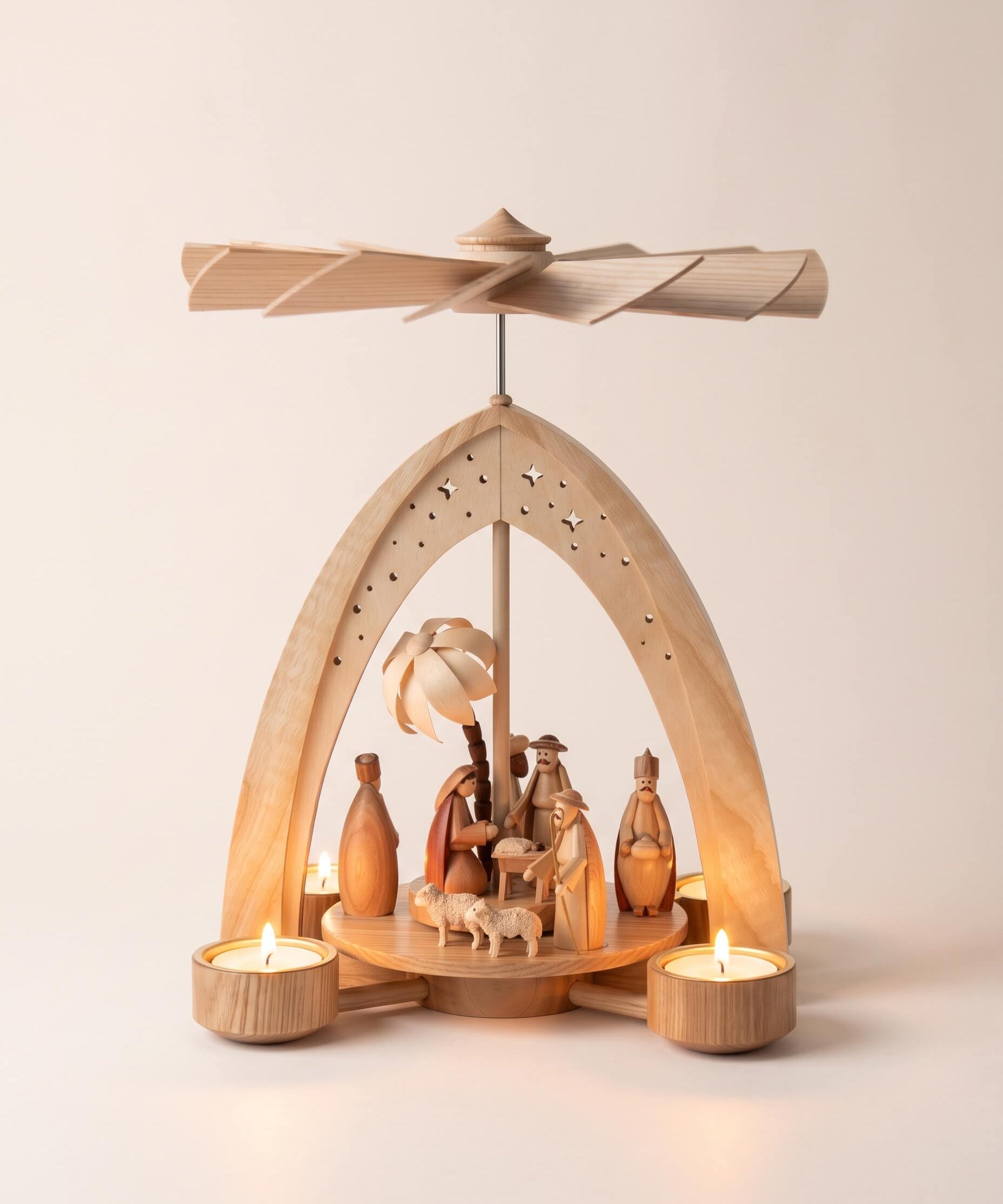 Hand-painted wooden nativity tealight pyramid with the Holy Family and wise men under a star-cut arch, made in Seiffen