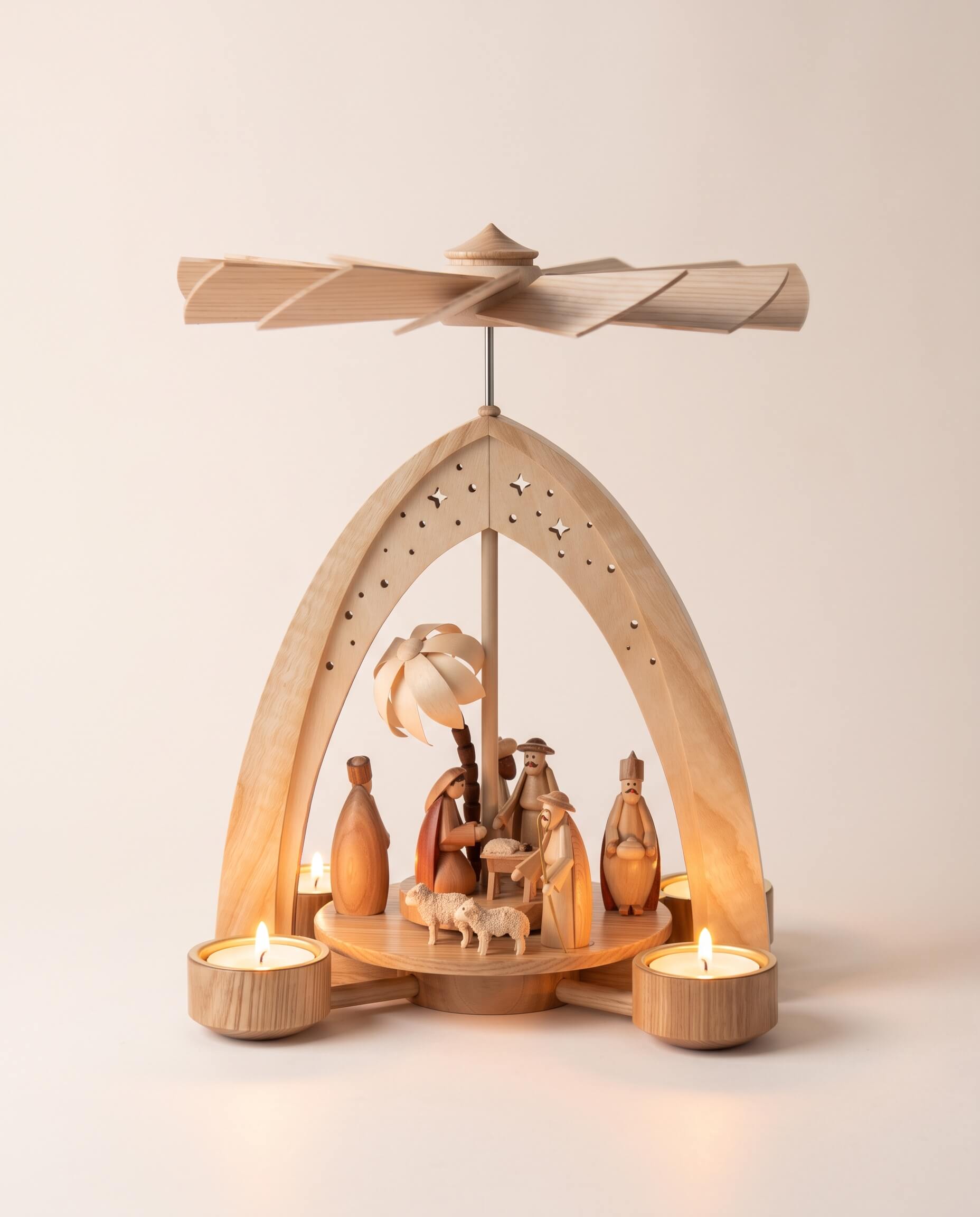 Hand-painted wooden nativity tealight pyramid with the Holy Family and wise men under a star-cut arch, made in Seiffen