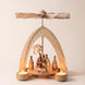 Hand-painted wooden nativity tealight pyramid with the Holy Family and wise men under a star-cut arch, made in Seiffen