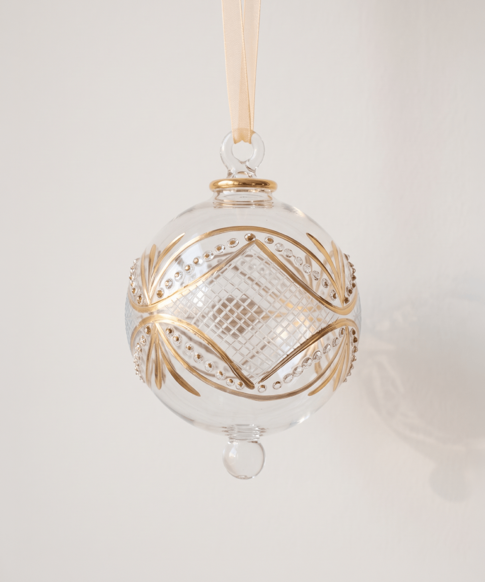 Hand-blown clear glass bauble circled with gold carousel bands, made in Old Cairo, Egypt