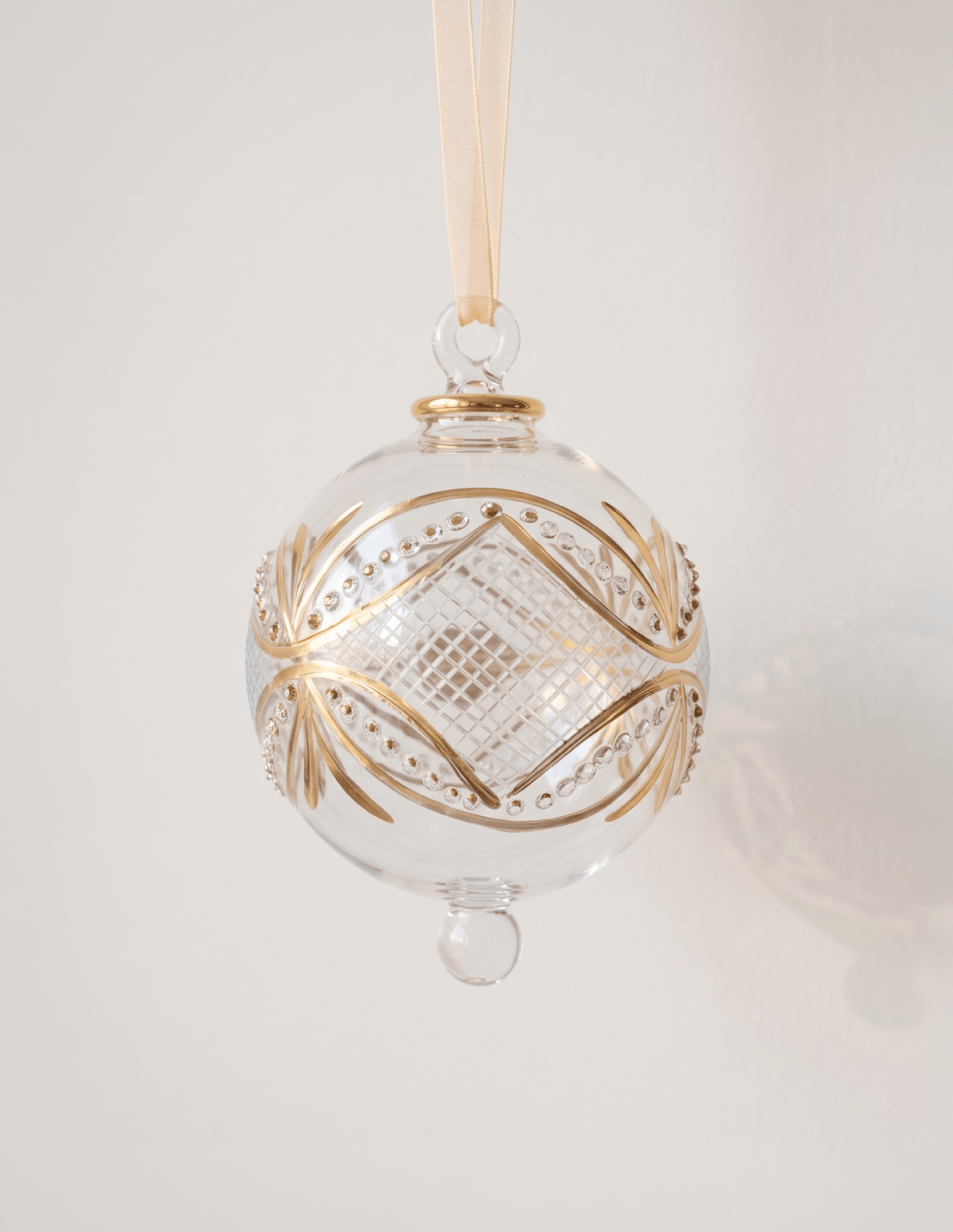 Hand-blown clear glass bauble circled with gold carousel bands, made in Old Cairo, Egypt