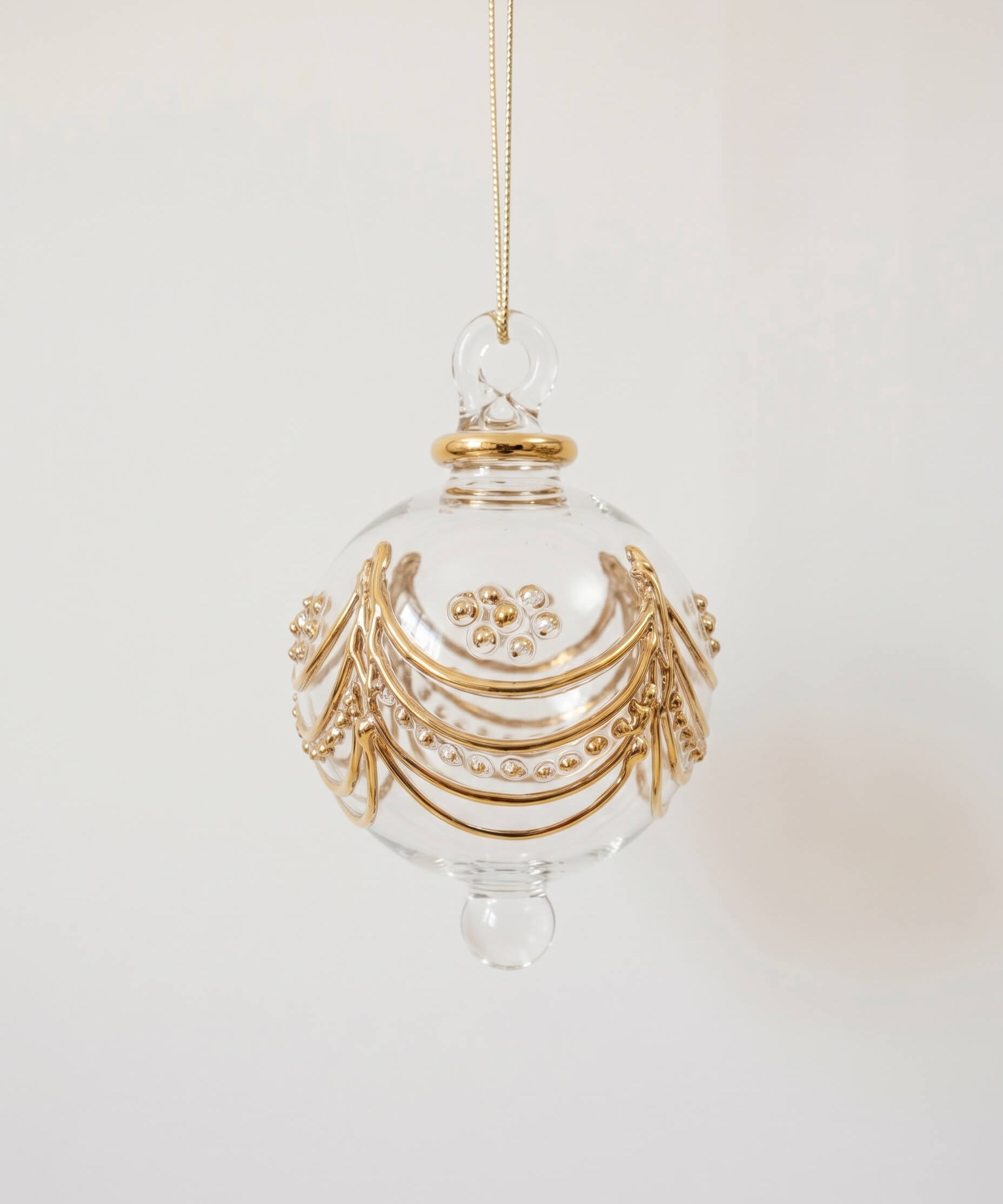 Hand-blown clear glass bauble painted with delicate gold drapes, made in Old Cairo, Egypt