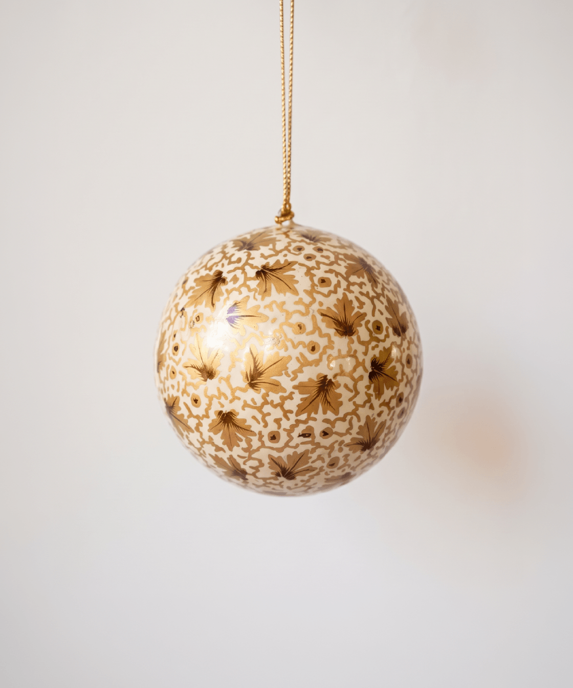 Ivory papier-mache ornament hand-painted with golden vines in Kashmir