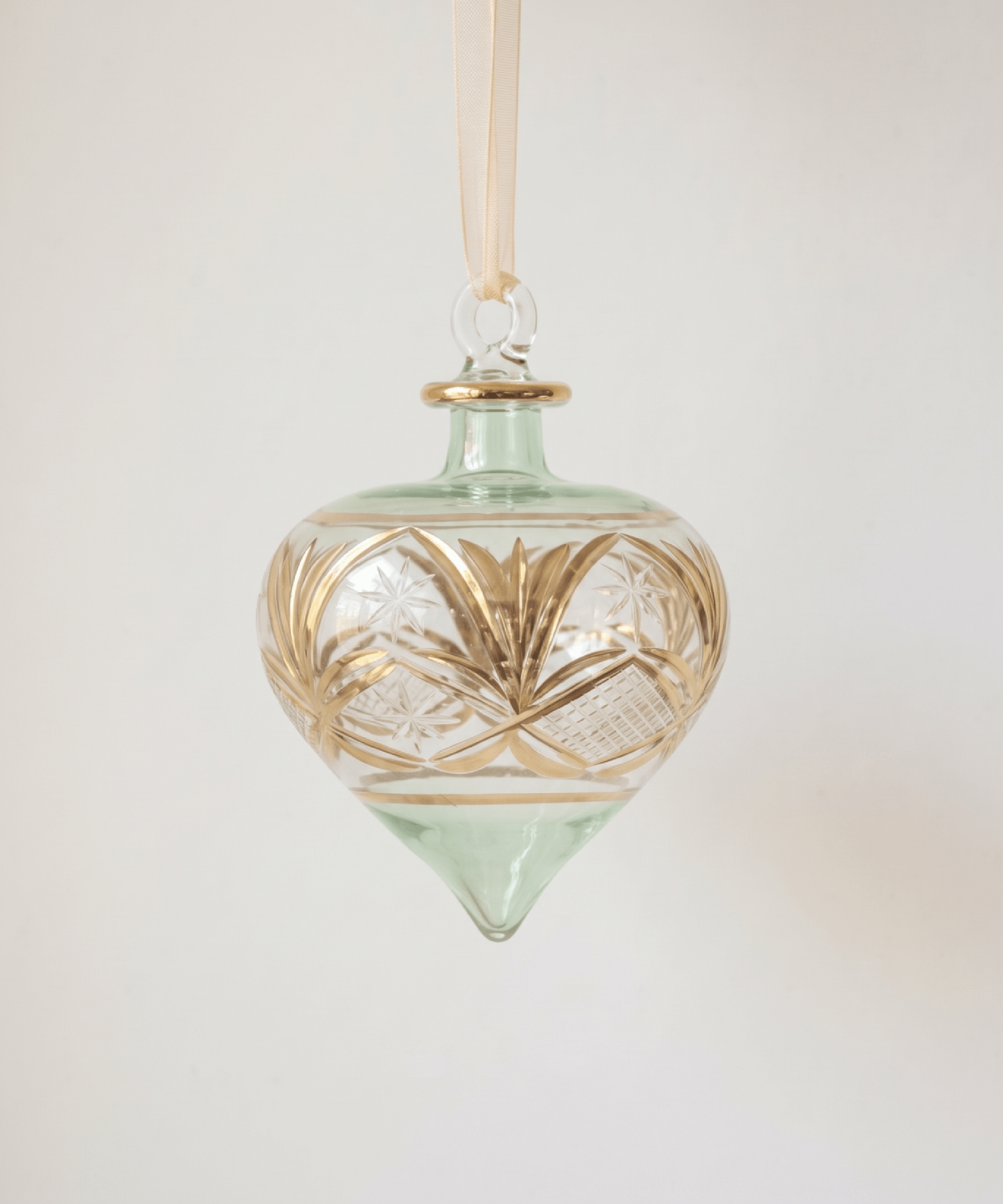 Hand-blown green glass droplet ornament brushed with gold accents, made in Old Cairo, Egypt