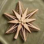 Hand-carved lime wood star tree topper with curled wood chip points, made in Seiffen, Germany