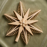 Hand-carved lime wood star tree topper with curled wood chip points, made in Seiffen, Germany
