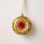 Silvered glass reflector ornament with a red, green and gold painted centre and gold glitter rim, by Inge-Glas of Germany
