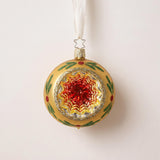 Silvered glass reflector ornament with a red, green and gold painted centre and gold glitter rim, by Inge-Glas of Germany